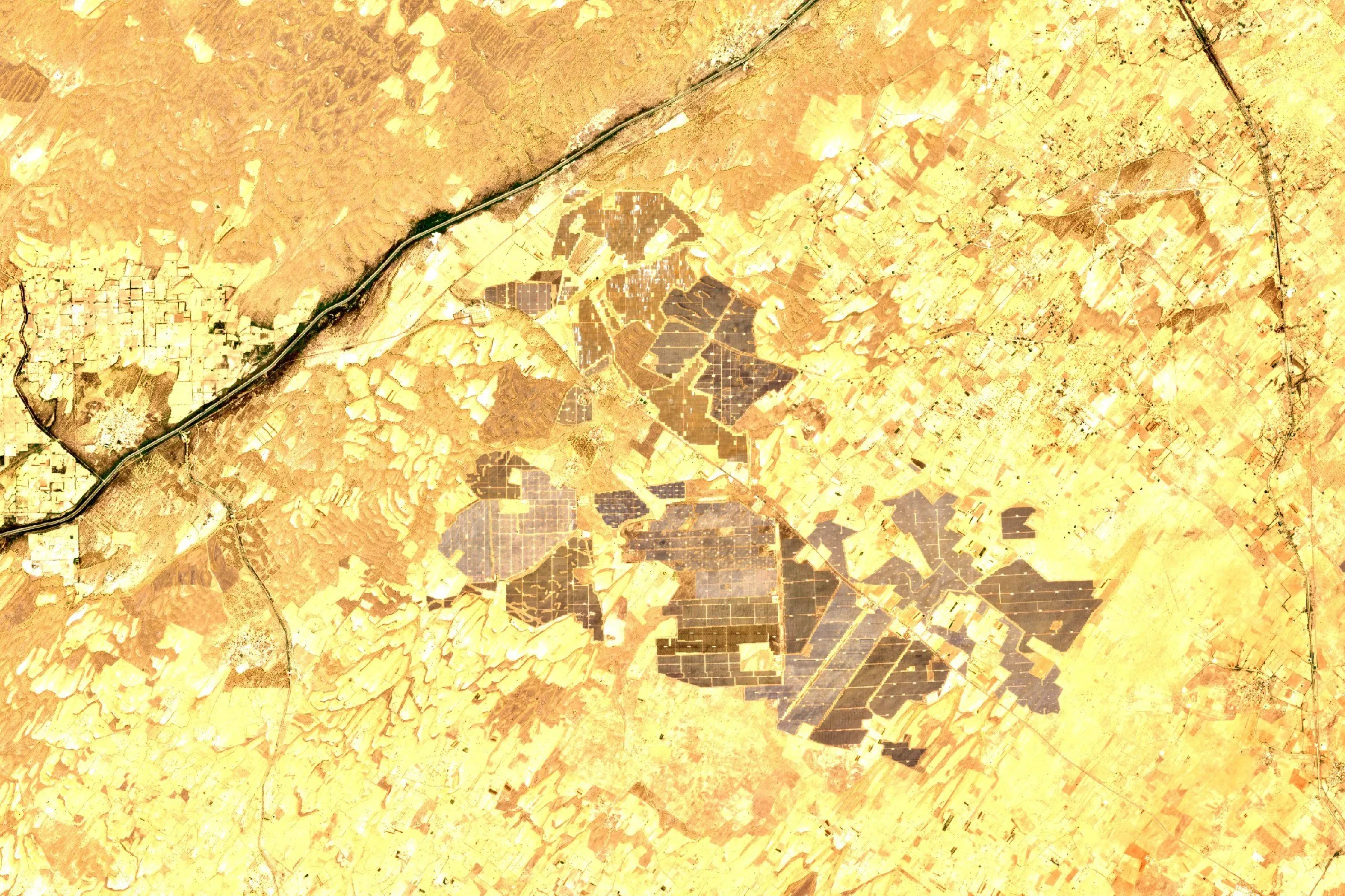 Satellite view of the grey rectangular arrays of a large solar park in the Rajasthan desert