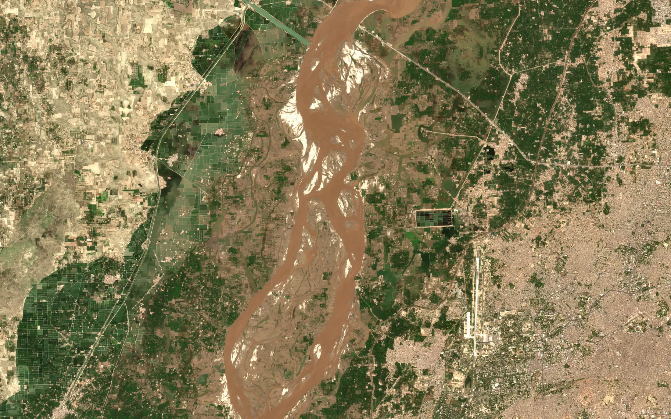 Sentinel-2 true-colour view of the Chenab in flood near Multan, Punjab, on 23 September 2025, with brown floodwater filling the braided river and spreading over the fields on both banks, and an airport runway to the east
