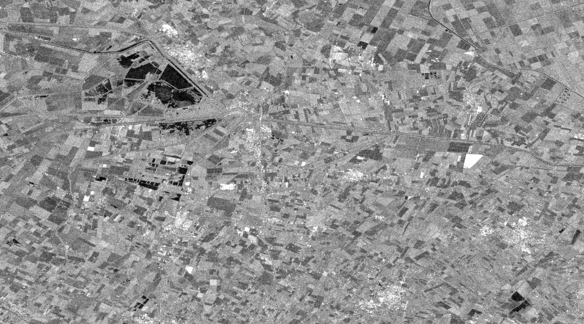 Radar image of the plain around Conselice on 10 May 2023. Fields are mid grey with a few small dark ponds and no large dark areas.