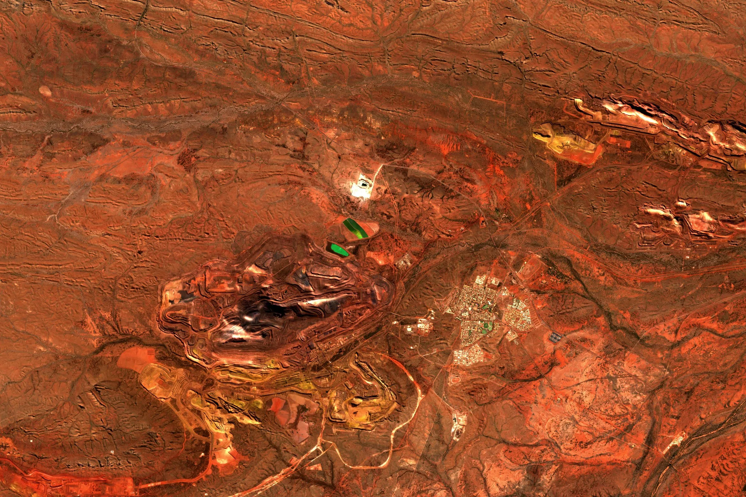 Satellite view of the Mount Whaleback iron ore mine in the red Pilbara landscape of Western Australia