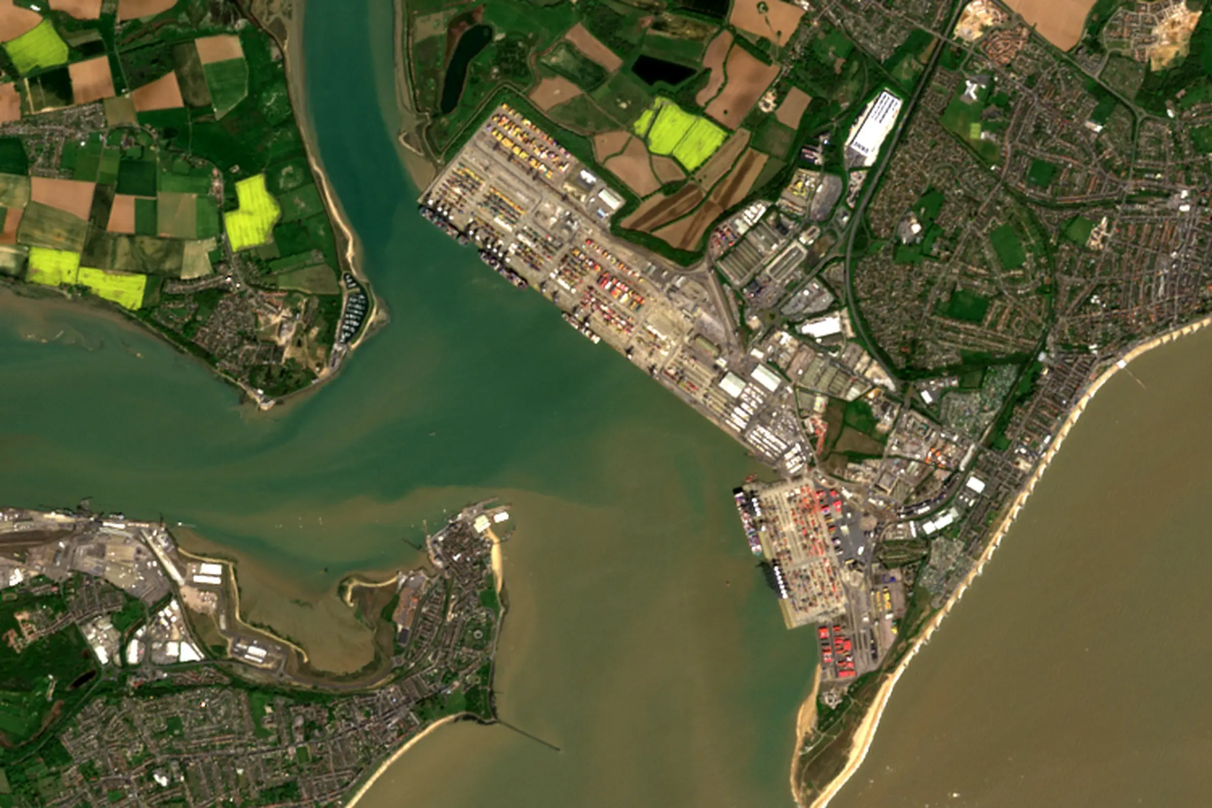 Satellite view of the container terminal at Felixstowe on the Orwell and Stour estuary, with Harwich across the water and farmland behind