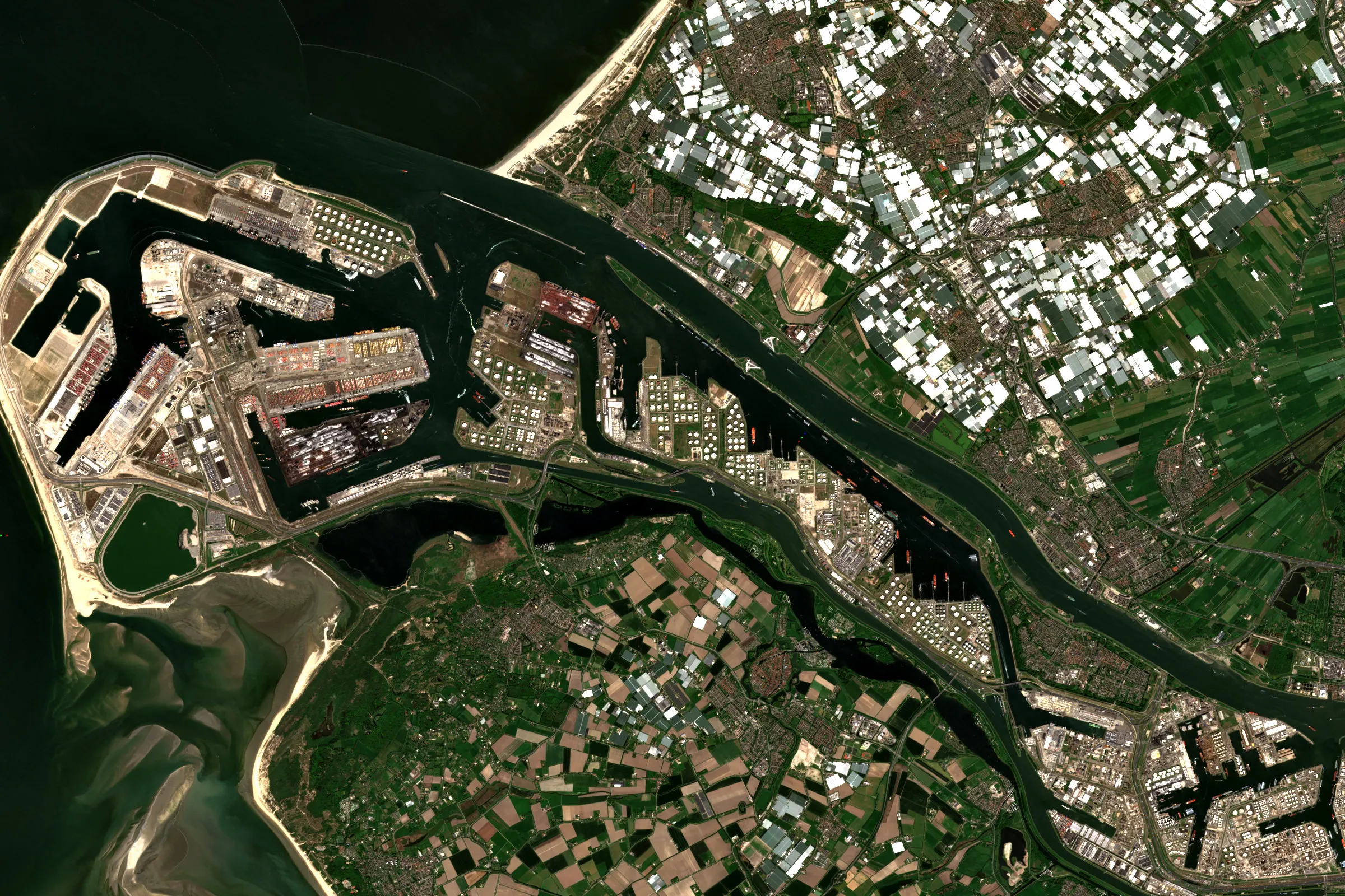 Satellite view of the Port of Rotterdam, with oil storage, refineries and container terminals along the Nieuwe Waterweg